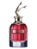 Red perfume bottle with silver nozzle on a black background